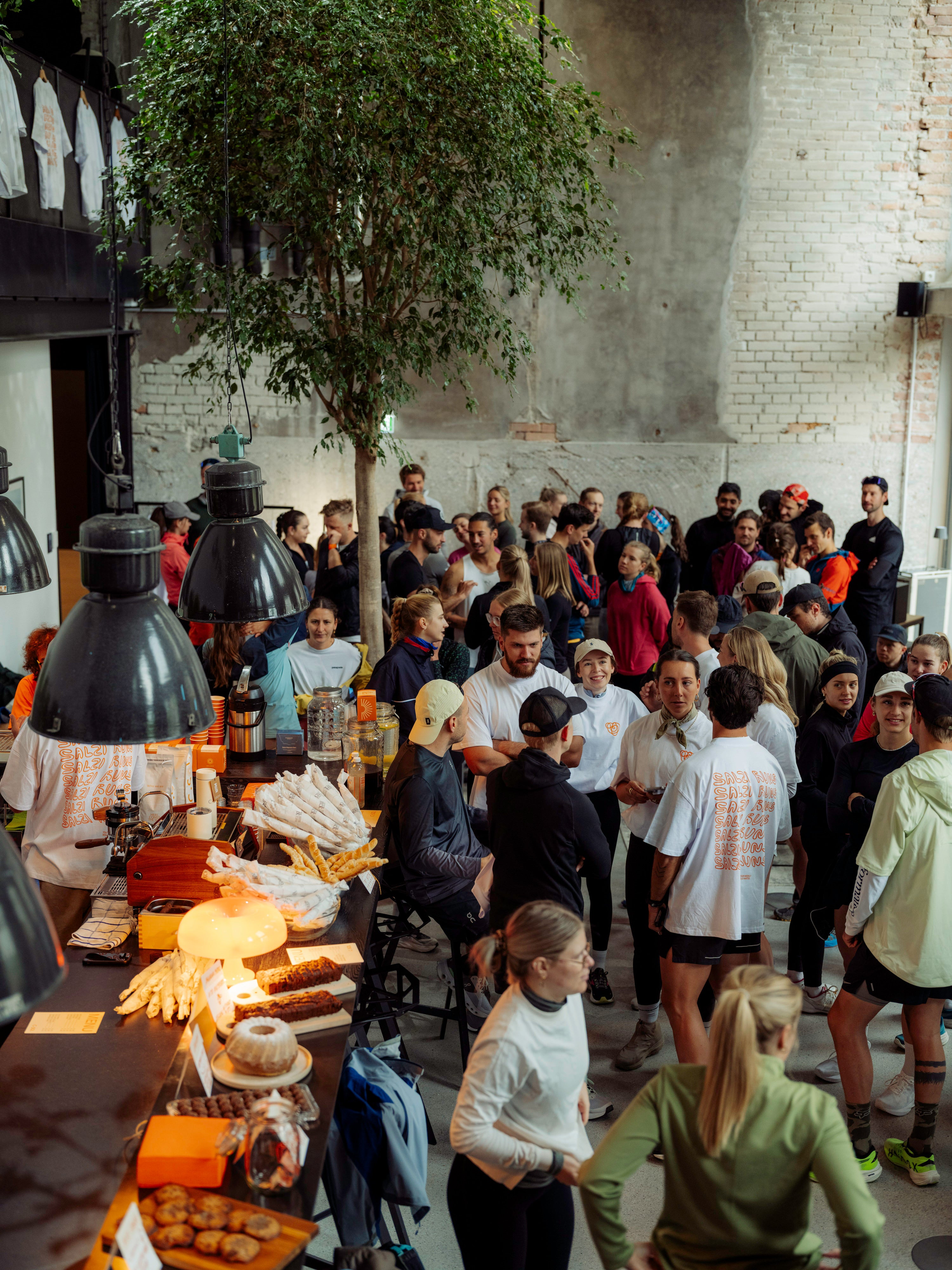 Crowd of people at an event with food stalls in a casual setting