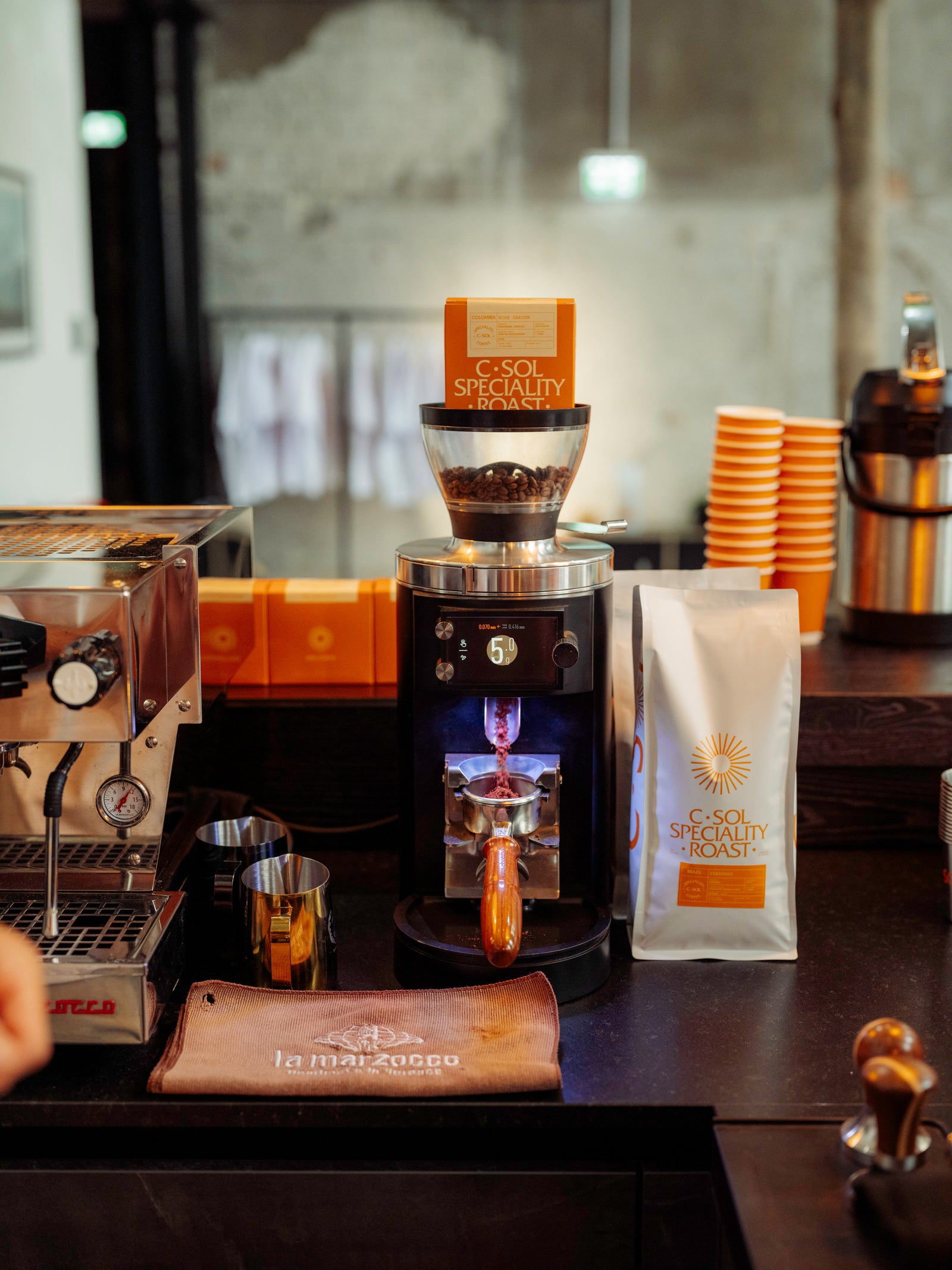 La Marzocco Espresso machine with a bag of coffee beans on a counter