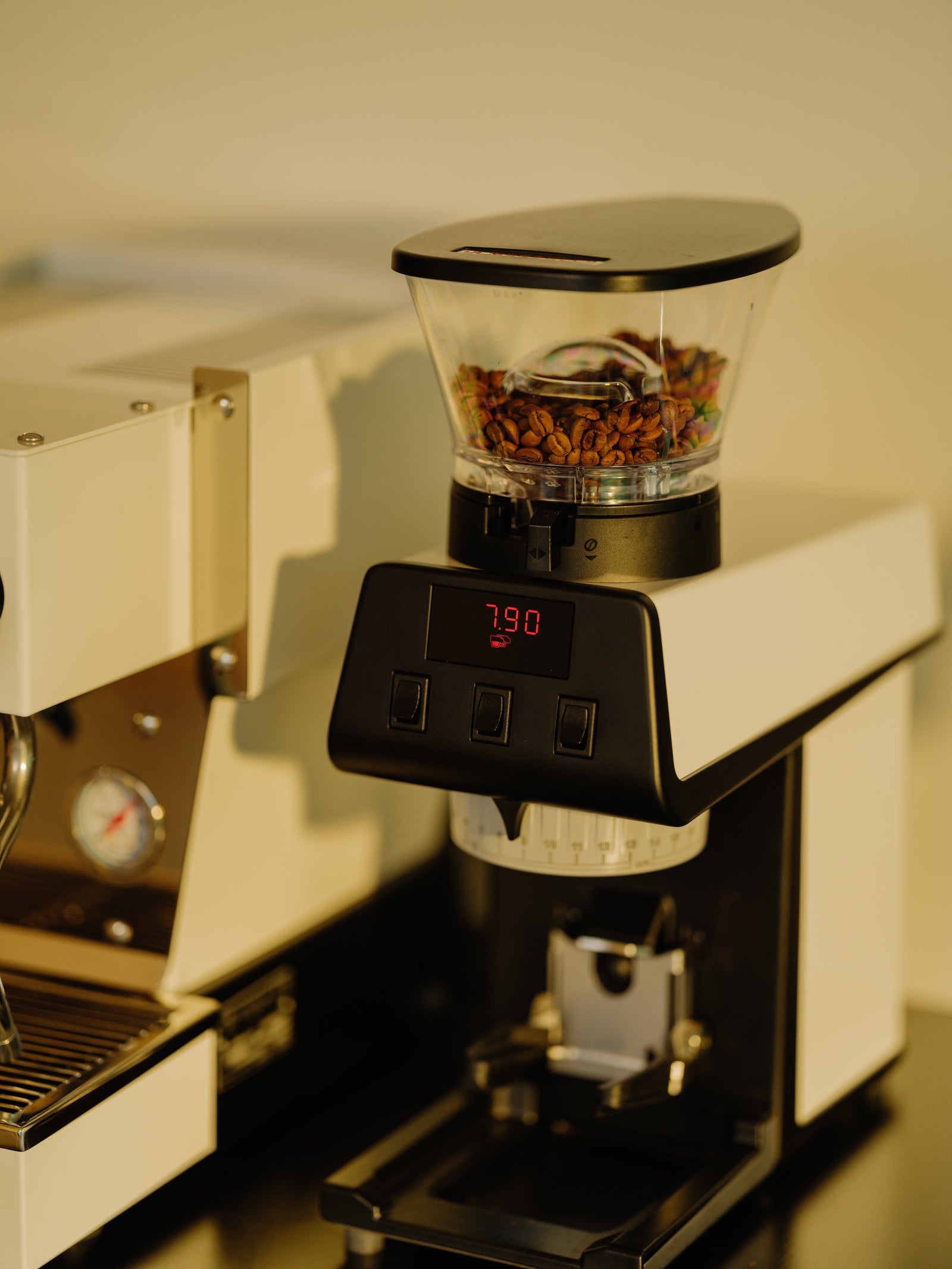 La Marzocco Pico coffee grinder with a digital display showing 7.90, right next to a La Marzocco Micra coffee machine